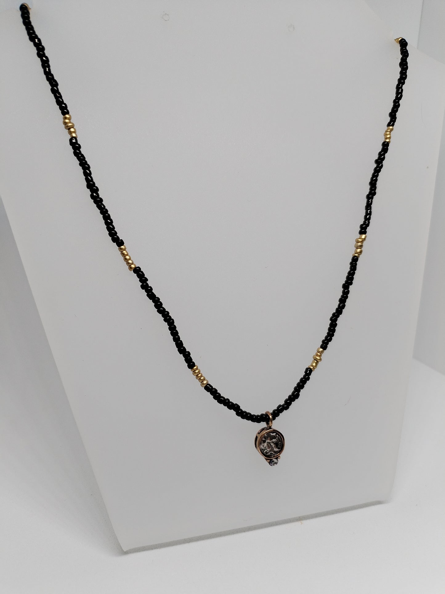 Black & gold beaded necklace with vintage pendant