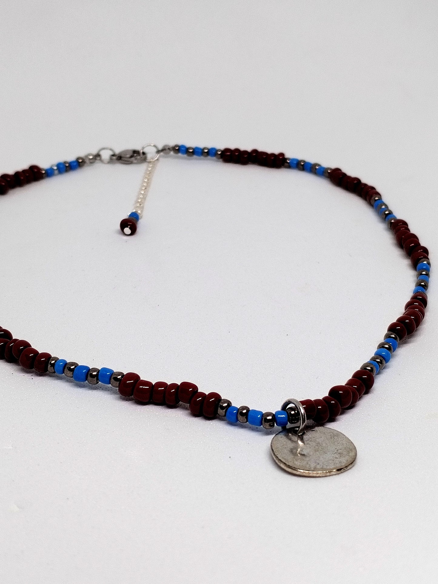 Brown & blue beaded necklace with silver tone disc