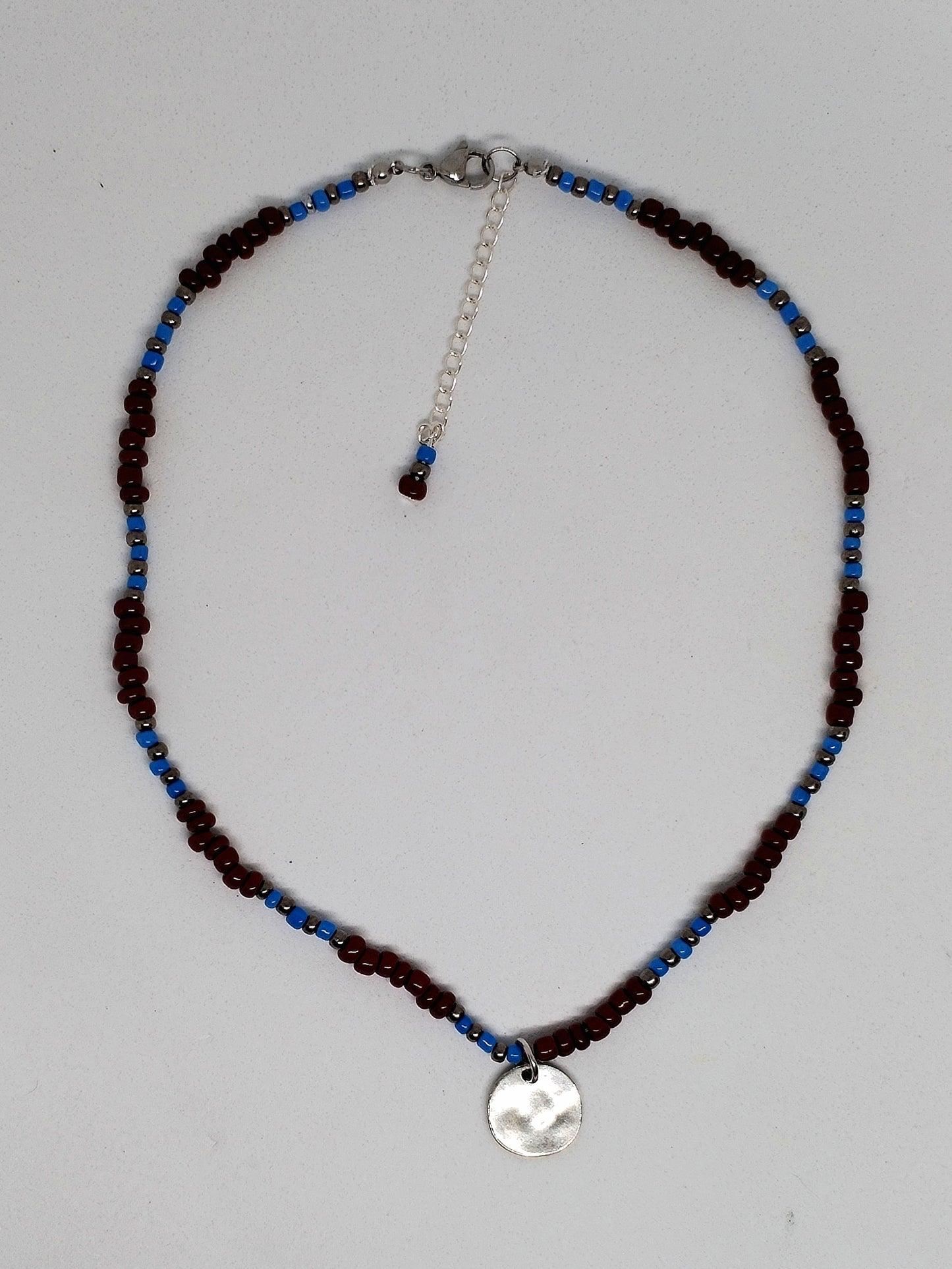 Brown & blue beaded necklace with silver tone disc